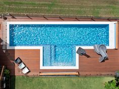 an overhead view of a swimming pool with lounge chairs