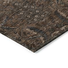 an area rug with brown and black floral design on the bottom, along with a white background