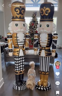 two large nutcrackers are standing next to a small dog