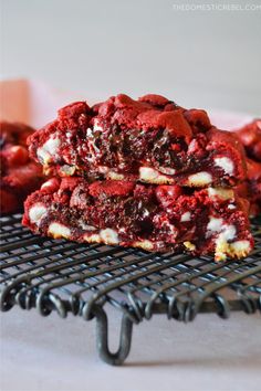 red velvet cookie bars stacked on top of each other with white chocolate chips and cherries