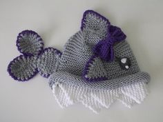 two crocheted hats with purple and white trim