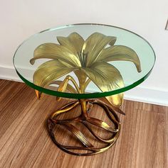 a glass table with gold flowers on it