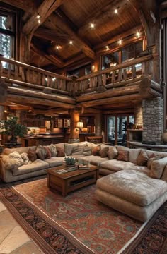 a living room filled with lots of furniture next to a tall wooden ceiling mounted above a fire place
