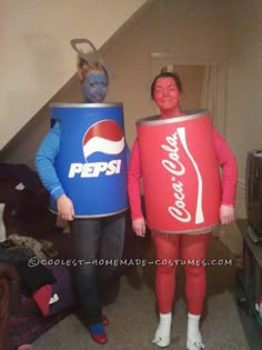 two people dressed in costumes standing next to each other with pepsi cans on their heads