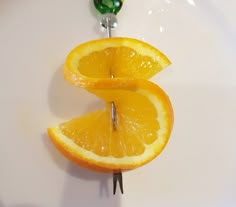 two oranges are cut in half and placed on a toothpick to hold them together