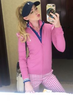 a woman taking a selfie with her cell phone in front of her face while wearing pink and blue pajamas