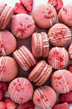 pink macaroons with white stripes and red sprinkles