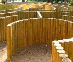 a circular wooden structure in the middle of a park