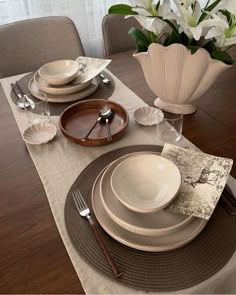 the table is set with plates and silverware