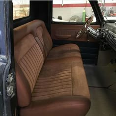 the interior of an old car with leather seats