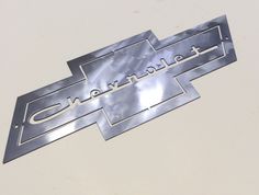 the chevrolet logo is shown in silver on a white background