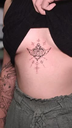 a woman's stomach with tattoos on it