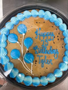 a birthday cake with blue frosting and balloons on it that says happy 25th birthday tyler