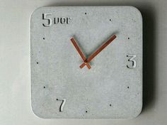 a clock made out of concrete with numbers on it