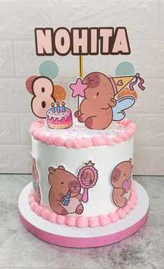 a birthday cake decorated with cartoon bears and a name on the top that says, nohta