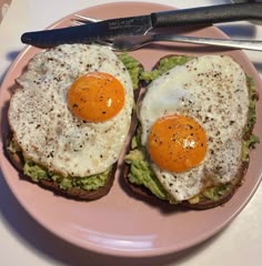 two eggs are on toast with avocado and breadcrumbs