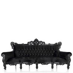 an ornate black velvet couch with carved arms and backrests, on a white background