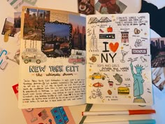 an open notebook with pictures and stickers on the pages, including new york city