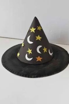 a black paper hat with stars and crescents on it