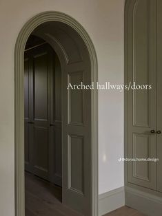 an arch in the wall between two doors with wood flooring and walls painted white