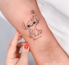 a small tattoo on the arm of a woman