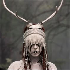 a woman with long hair and horns on her head