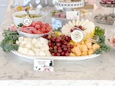 a platter filled with lots of different types of fruits and pastries on top of a table