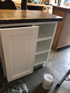 the cabinets are being painted white and ready to be installed