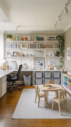 a living room filled with furniture and bookshelves next to a table on top of a hard wood floor