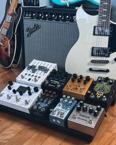 guitars and amps are lined up on the floor