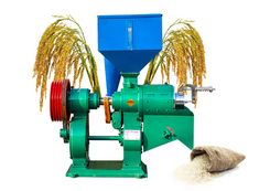 a machine that is sitting next to some wheat stalks and a sheep's head