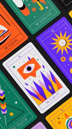 several colorful playing cards with space and stars on the top one has an eye in it