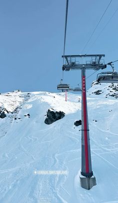 a ski lift going up the side of a snow covered mountain