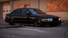 a black car parked in front of a building