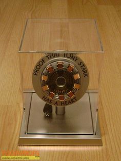 a clock that is sitting on top of a wooden table and has words written on it