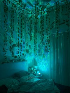 a bed in a room with green lights on the ceiling and curtains hanging from the ceiling