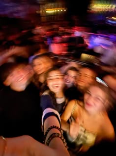 a group of people standing next to each other in front of a crowd at a concert