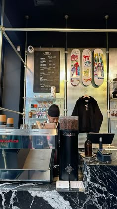 there is a counter with skateboards on the wall behind it and in front of them