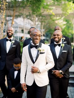 a group of men in tuxedos standing next to each other