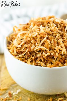 a white bowl filled with food on top of a wooden table