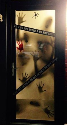 an image of handprints on the glass in front of a door with tape around it