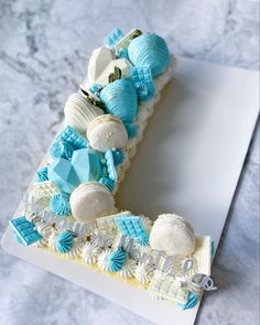a piece of cake that is decorated with blue and white decorations on top of it