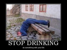 a man laying on top of a wooden bench