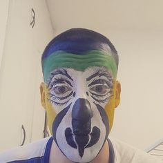a man with his face painted like a clown