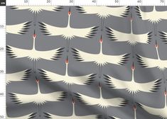 a gray and white bird pattern with red dots on it's wings, in front of a ruler