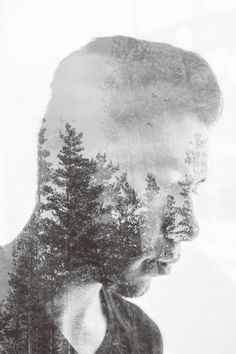 a man with trees reflected in his face
