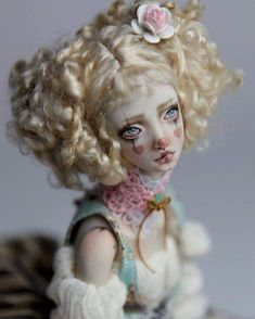 a doll with blonde hair and blue eyes