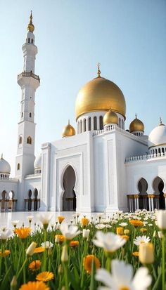 a large white building with a gold dome on top and flowers in the foreground