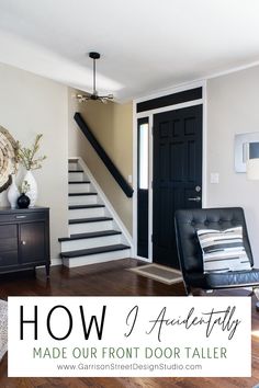 a living room with black doors and white stairs