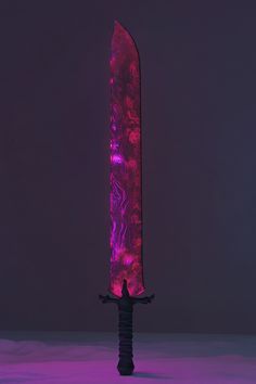 a large knife is lit up with purple light